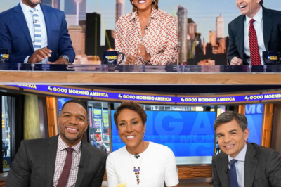 Good Morning America’s iconic trio—Robin, Michael, and George—are in utter shock and mourning this morning after a devastating blow behind the scenes. Watch the heart-wrenching moment Robin grasps Michael’s hand for support and George collapses off-camera.